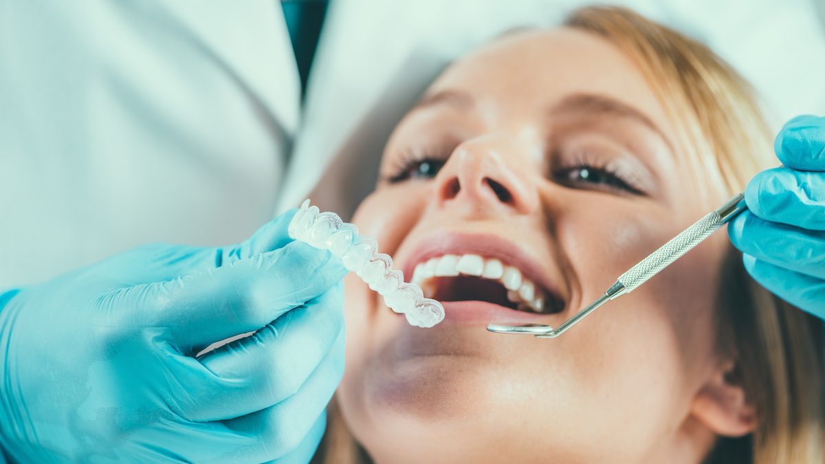 woman getting retainer put on