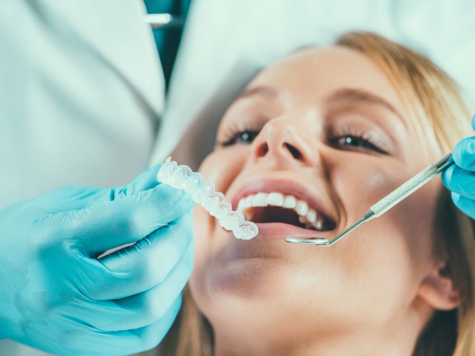 woman getting retainer put on