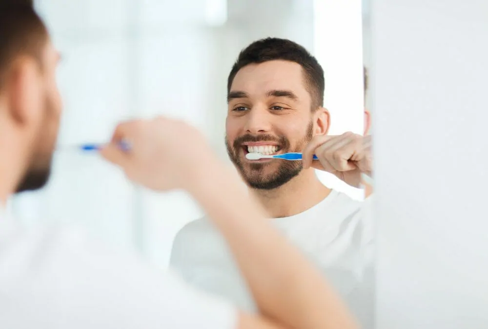 young man brushing his teeth