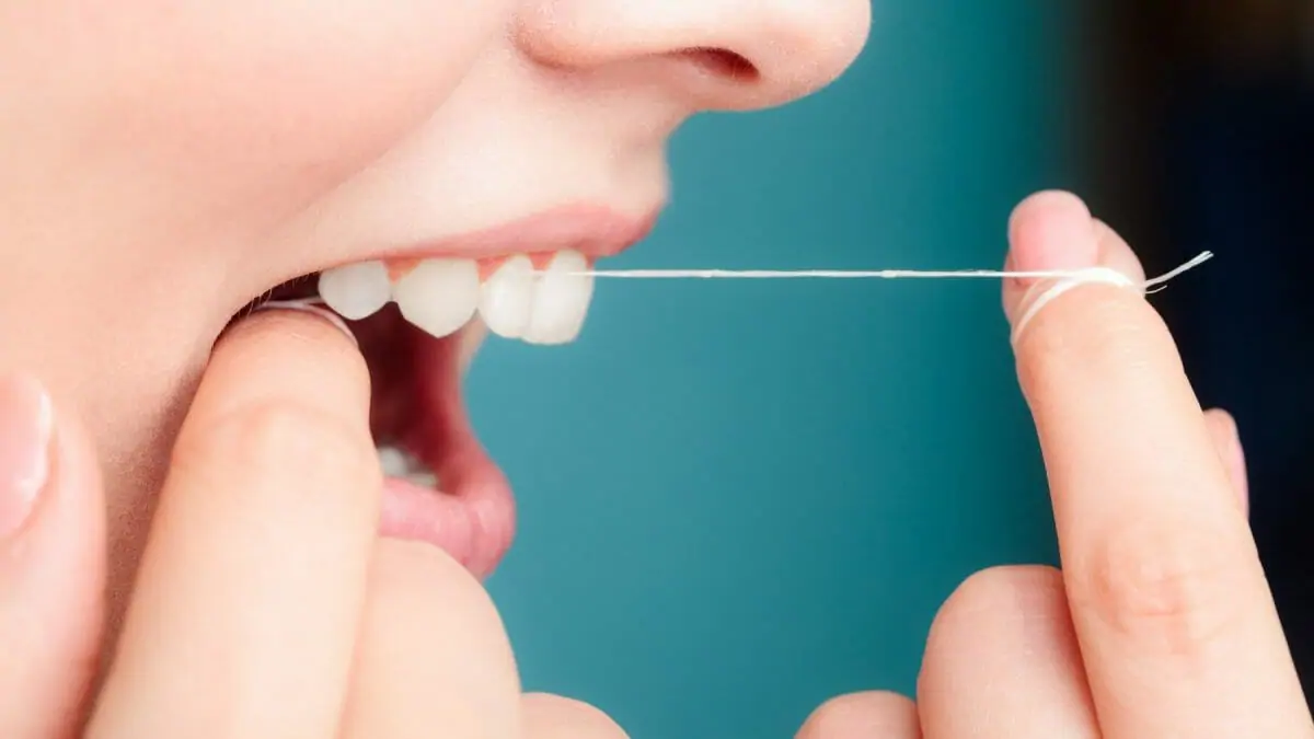 Woman flossing her teeth