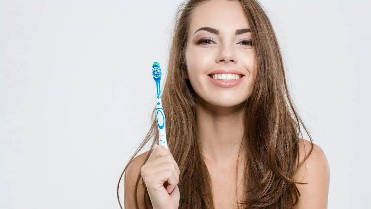 Woman holding a toothbrush