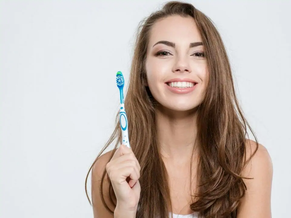 Woman holding a toothbrush