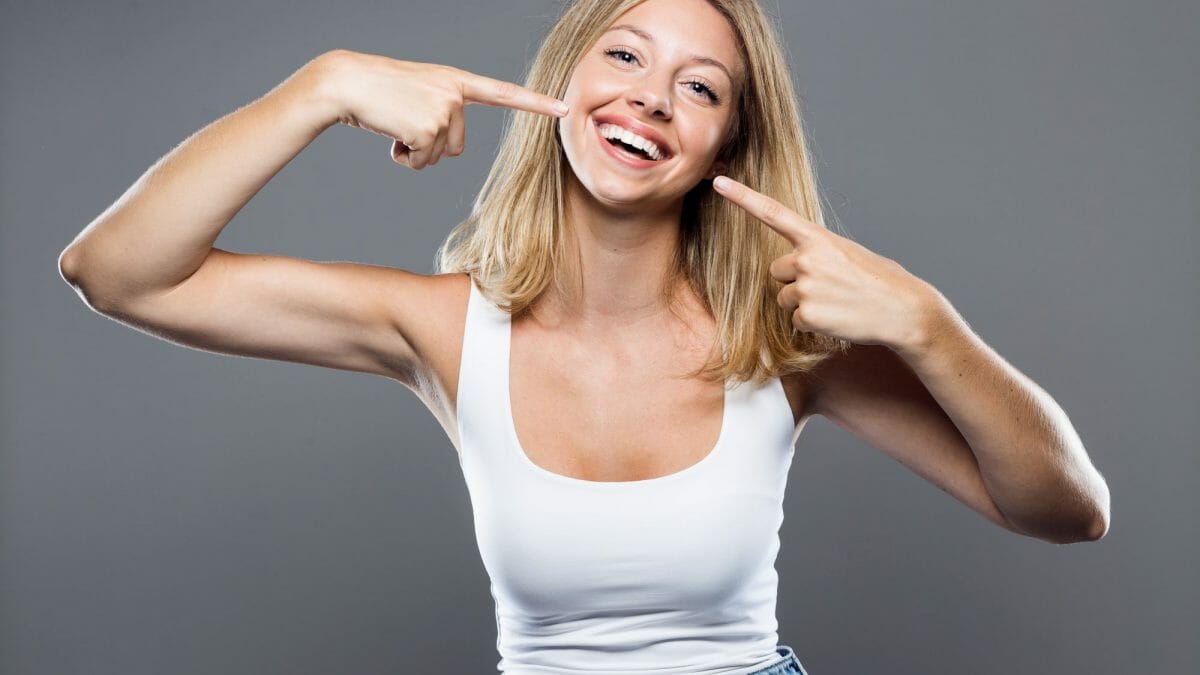 young woman pointing to teeth