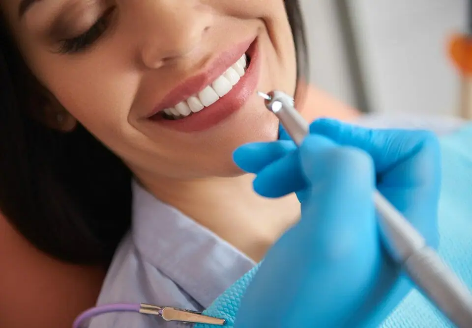 cleaning teeth for patient with white straight teeth