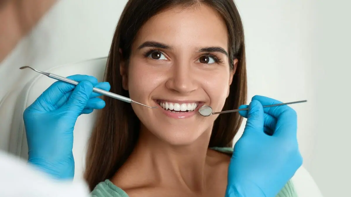 Woman with Dental Tools in Mouth