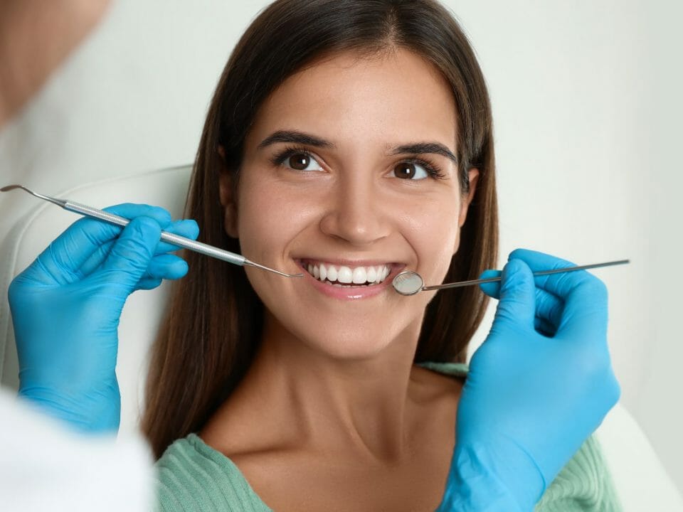 Woman with Dental Tools in Mouth