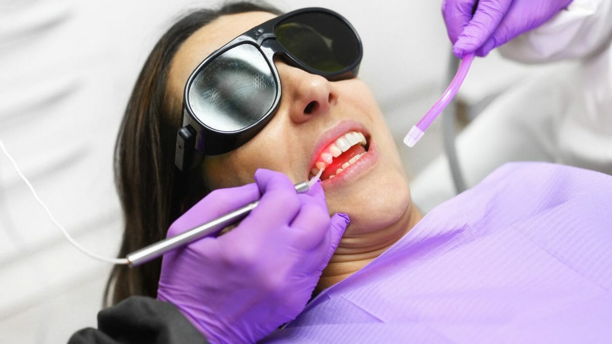 Dentist Using Laser Technology on Patient