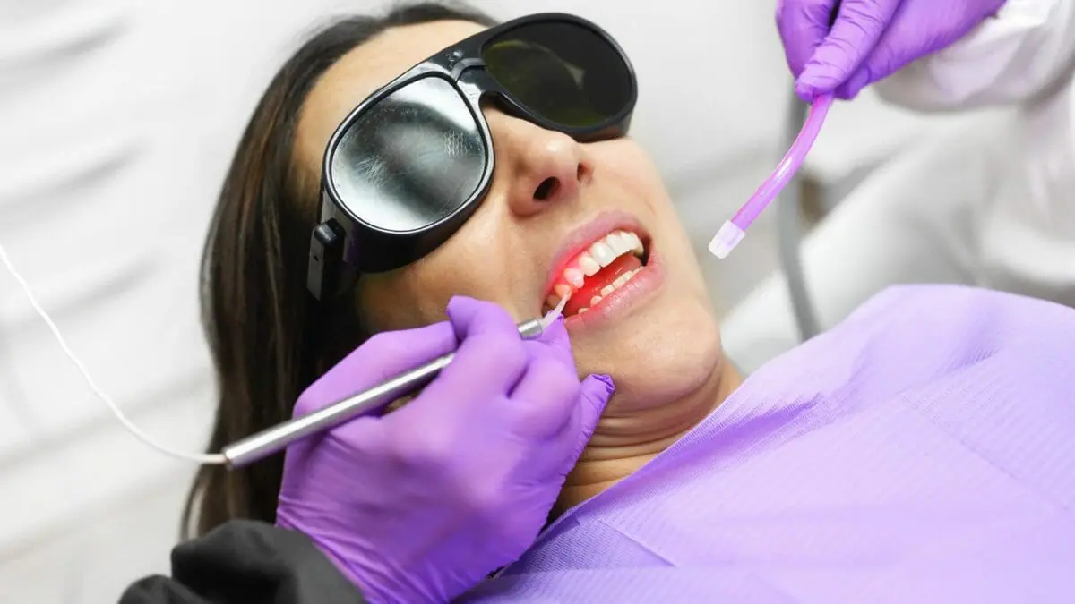 Dentist Using Laser Technology on Patient