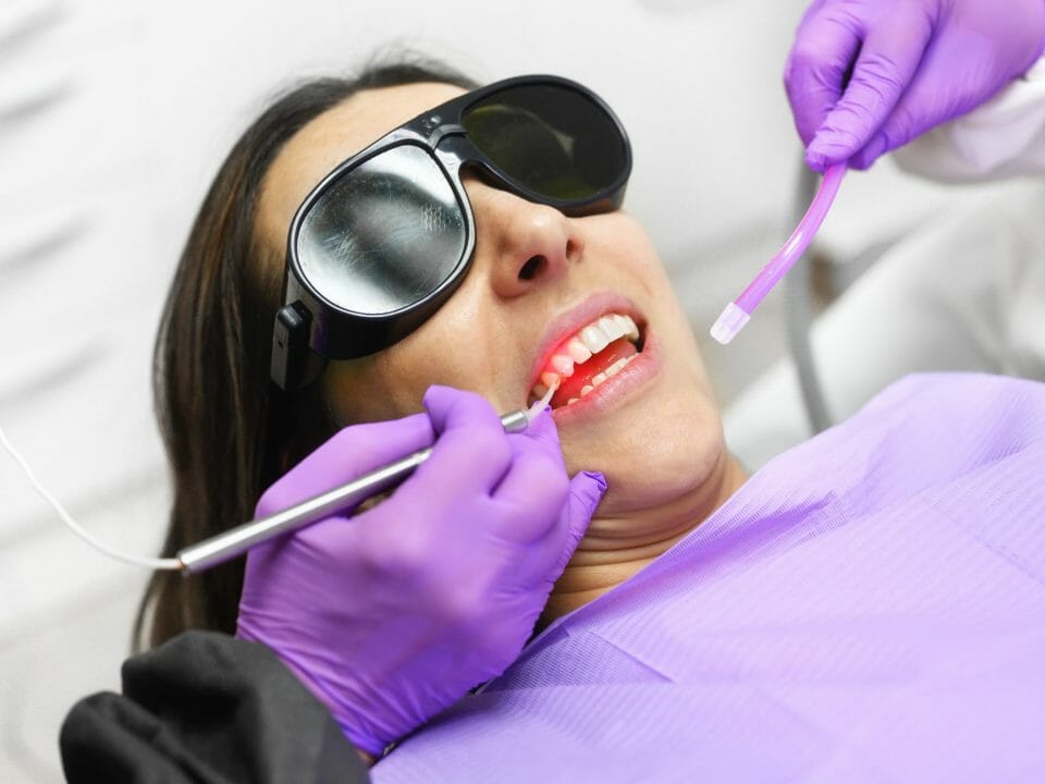 Dentist Using Laser Technology on Patient