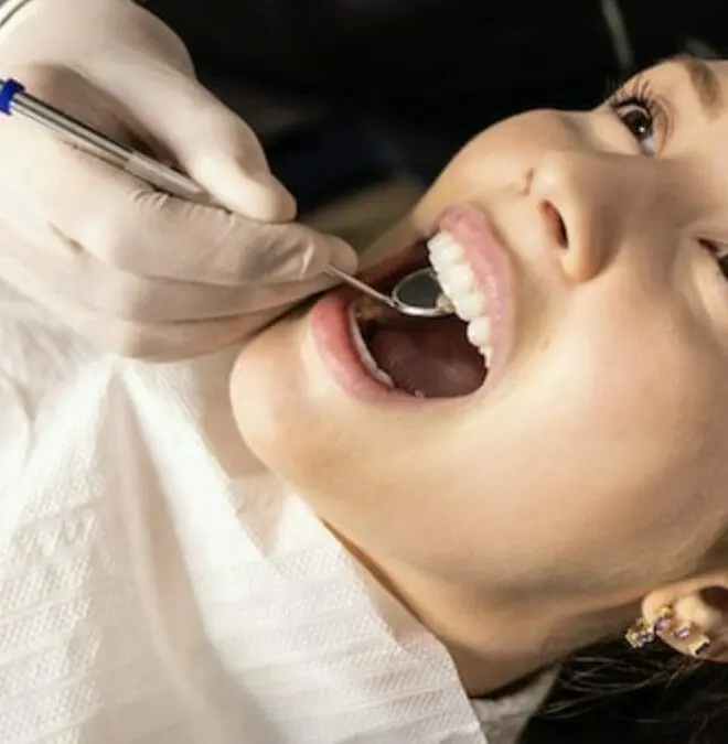 Girl getting her oral health checked.