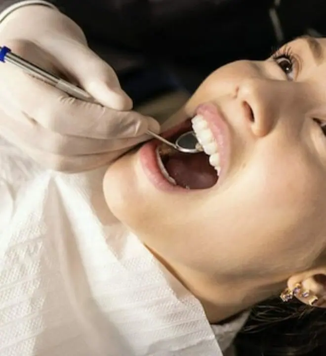 Girl getting her oral health checked.